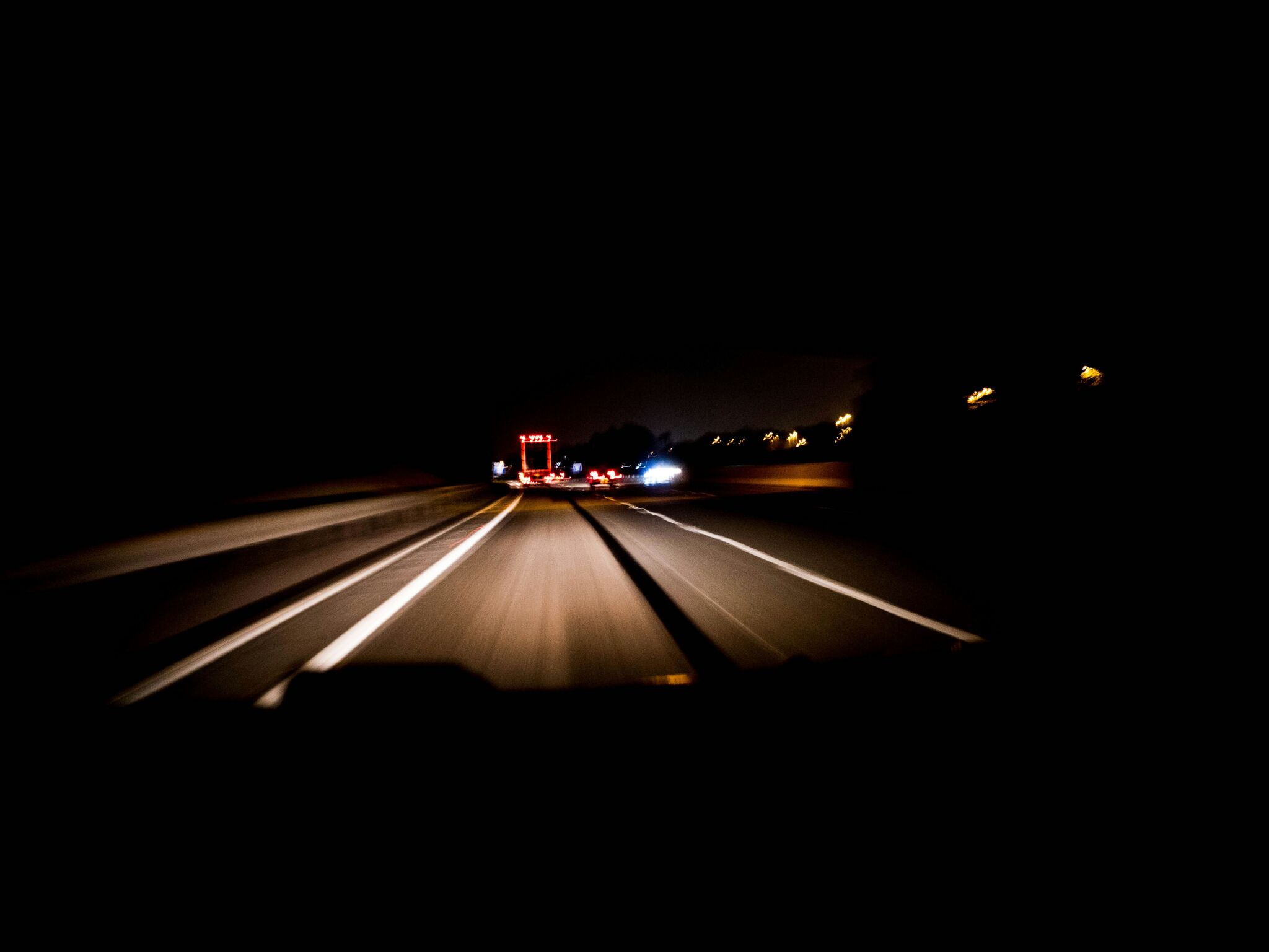 Dark road at night illlustrating headlights in action