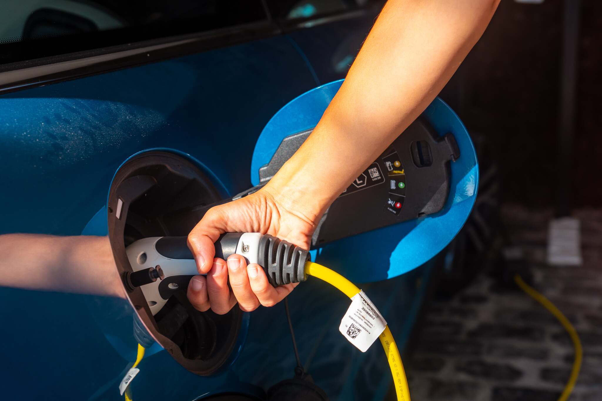 A woman charging an electric car charging the batt 2024 12 10 01 59 21 utc min
